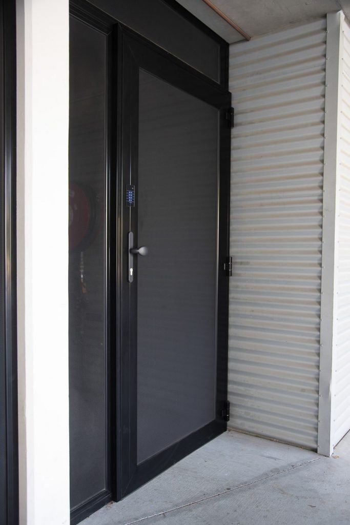 A black door with a white wall behind it