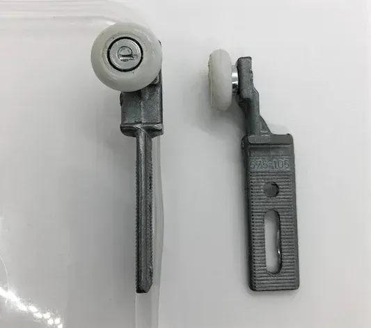 A pair of sliding glass door rollers on a white surface.