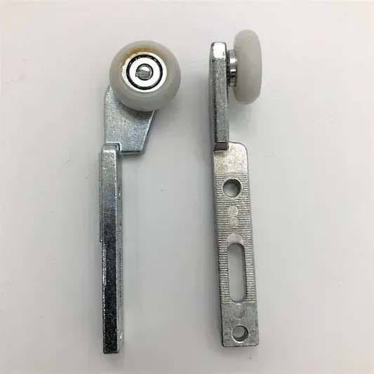 A pair of sliding glass door rollers on a white surface.