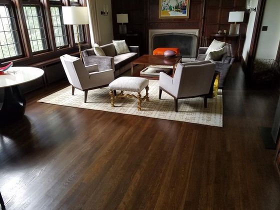 couple lying on rug on new hardwood flooring in Elyria, OH