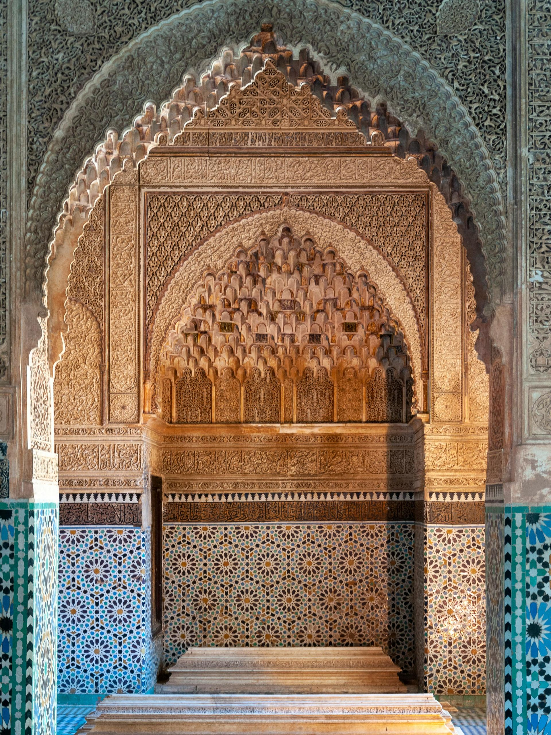Intricate archway in Moroccan style, with ornate carvings, mosaic tilework, and warm lighting.