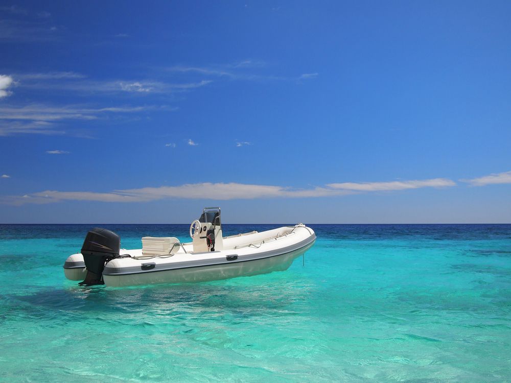 A White Boat is Floating on Top of a Turquoise Ocean — Crane Maintenance Queensland in Emerald,QLD