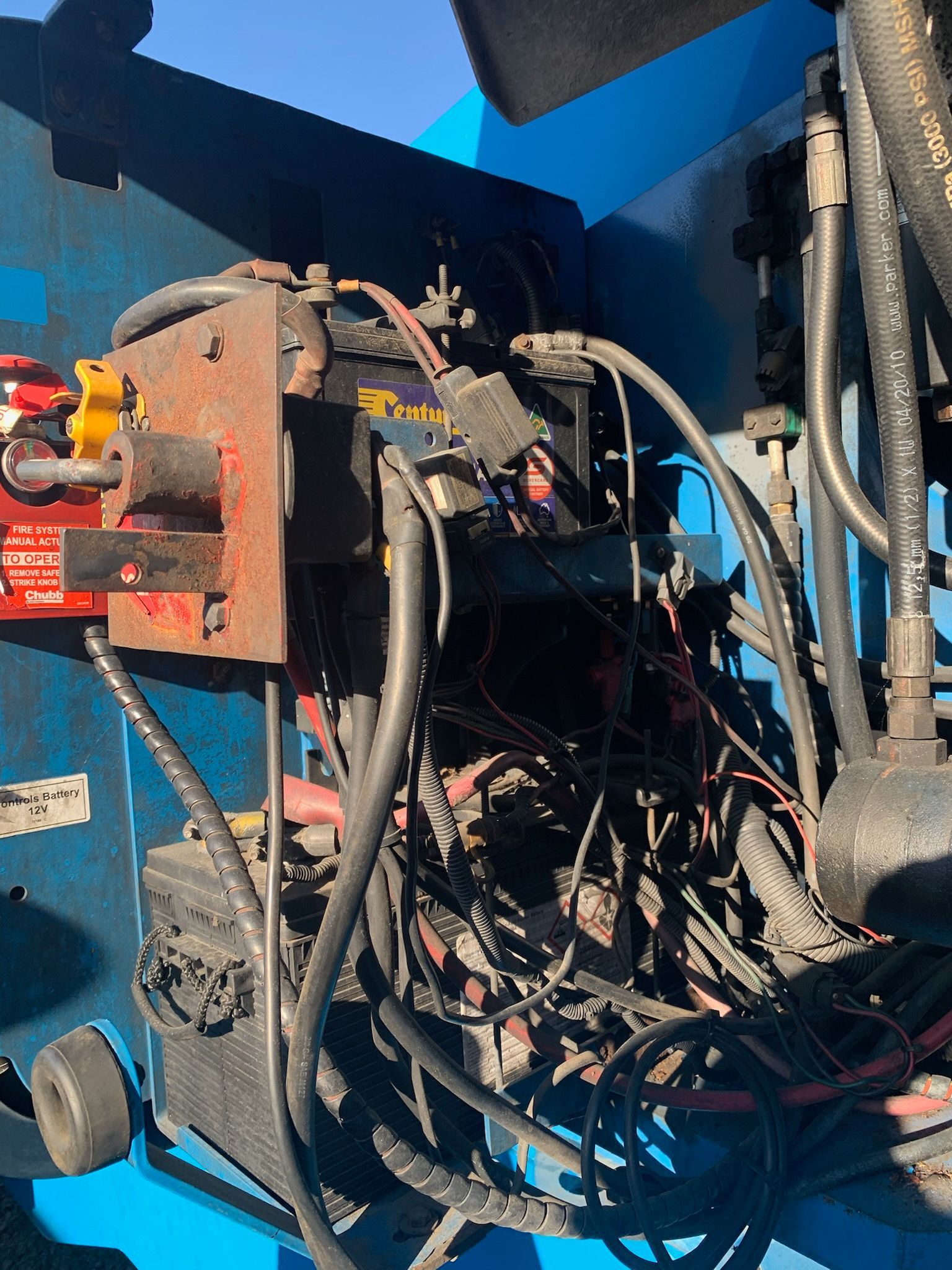 A Man is Writing on a Clipboard in Front of a Car Engine — Crane Maintenance Queensland in Moranbah,QLD