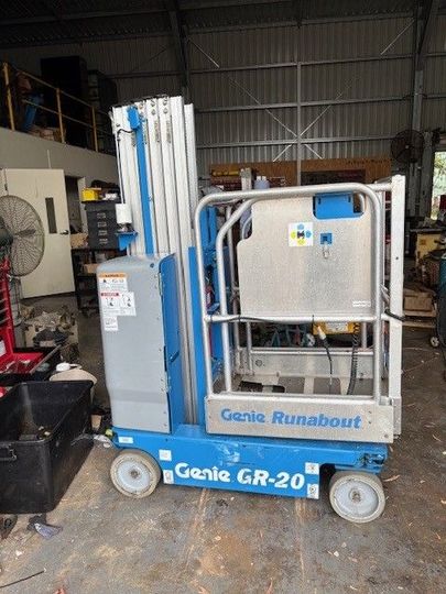 A Man is Working on a Machine in a Garage — Crane Maintenance Queensland in Slade Point, QLD