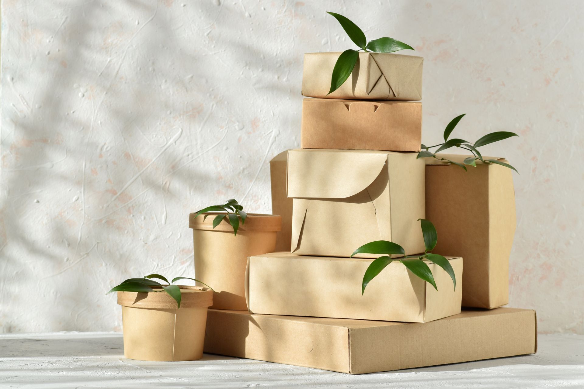 A stack of brown boxes sitting on top of each other on a table.