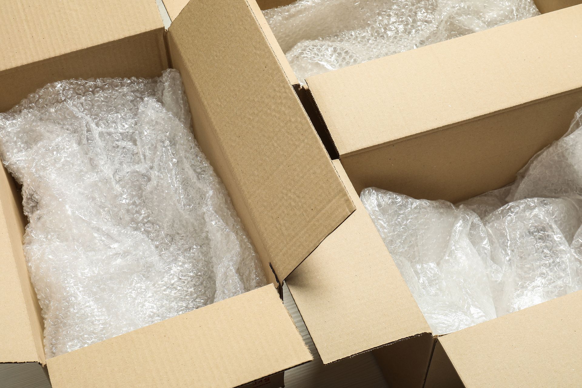 A stack of cardboard boxes filled with bubble wrap