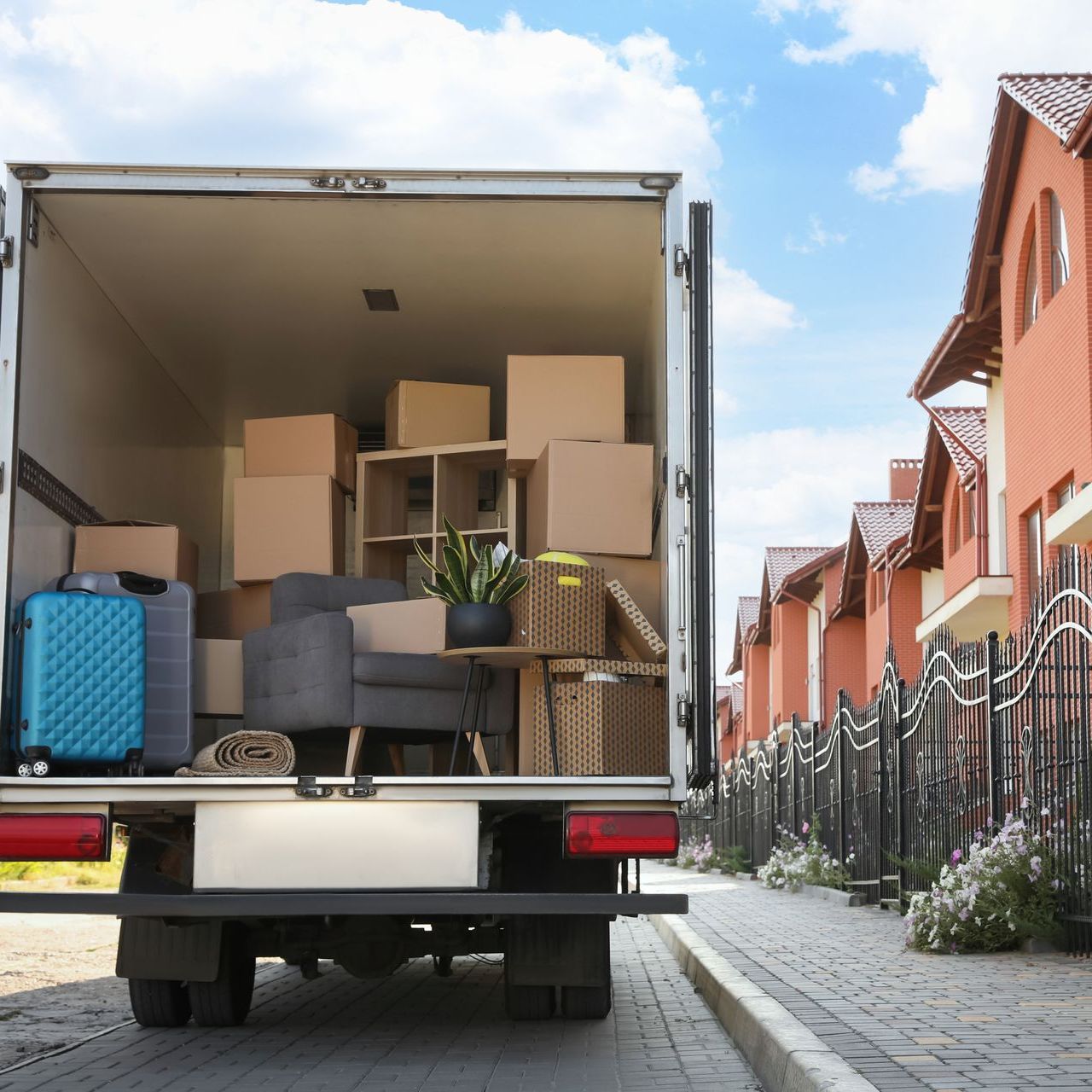 A moving truck is filled with boxes and luggage.