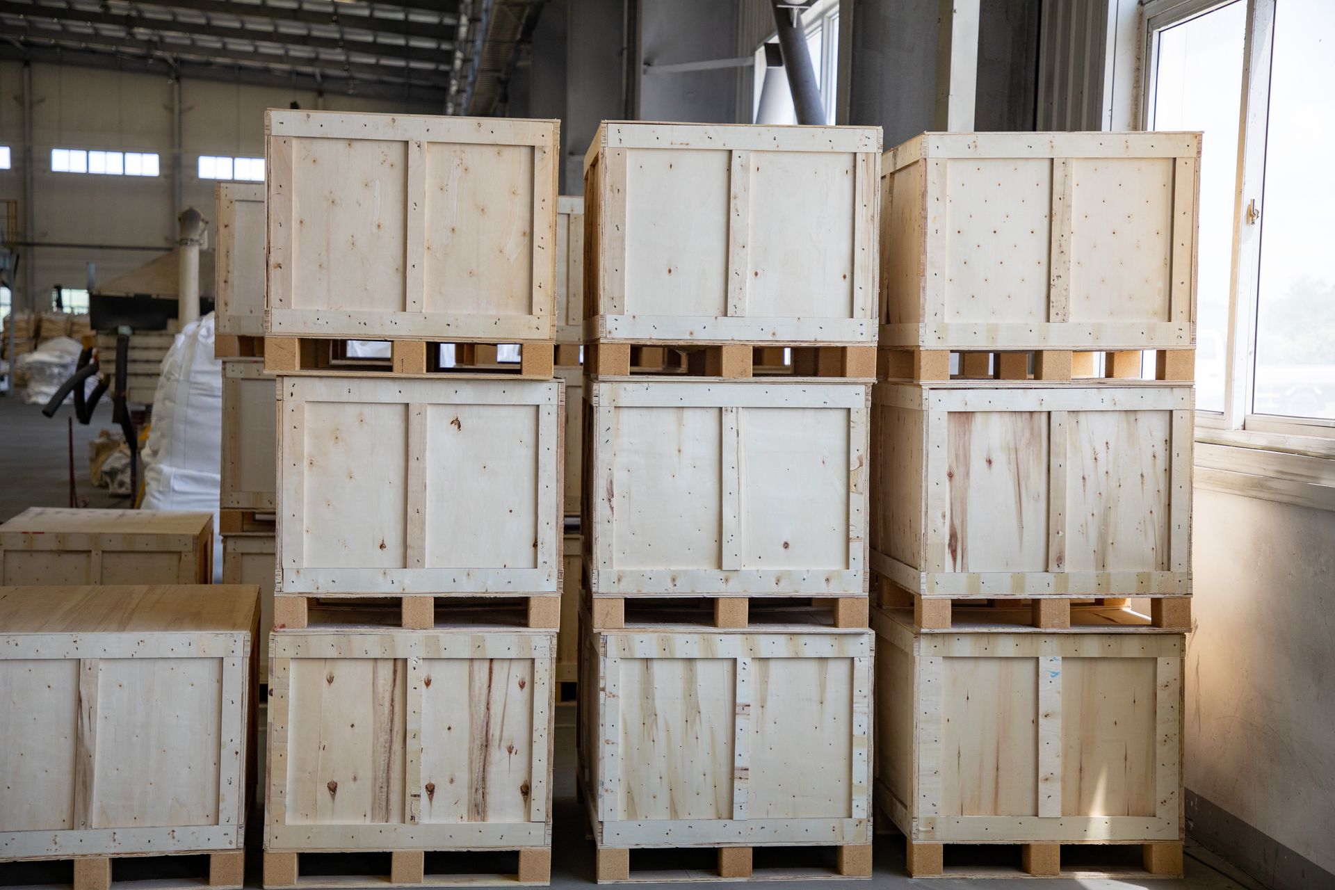 A warehouse filled with lots of wooden crates stacked on top of each other.