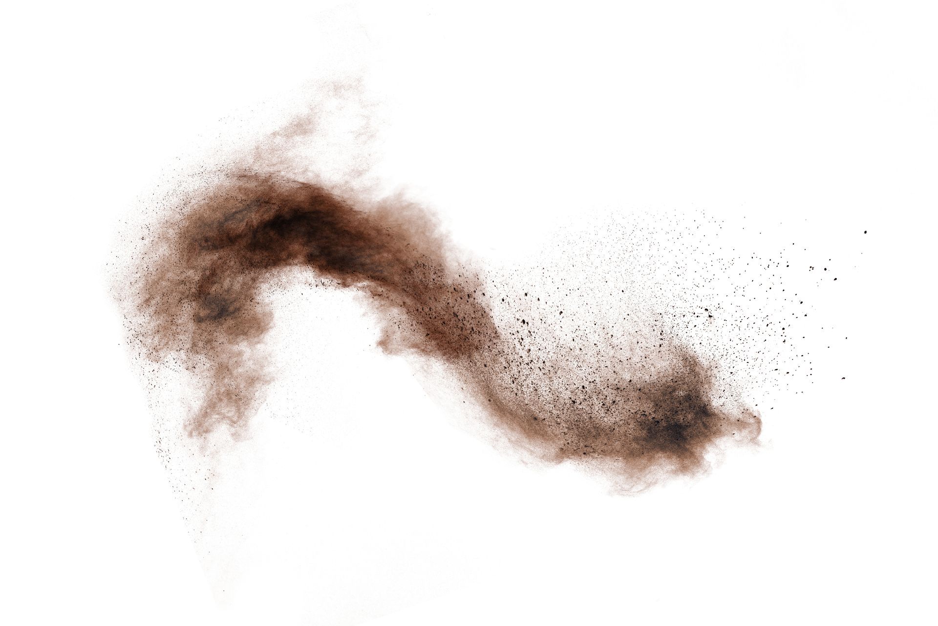 Brown powder exploding against a white background.