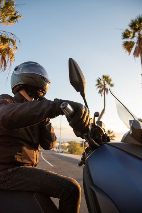 Older couple reviewing paperwork together at a table with a laptop in a bright home.