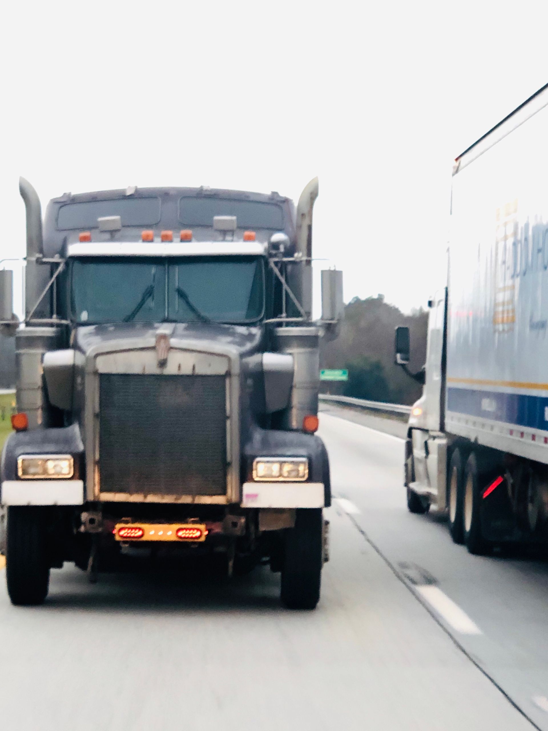 Older couple reviewing paperwork together at a table with a laptop in a bright home.