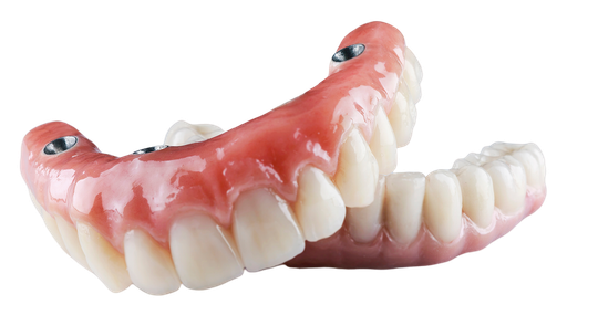 A close up of a denture on a white background.