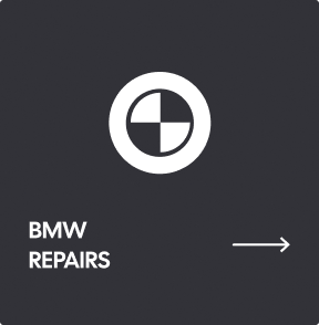 A dark gray sign with a white BMW logo and the text 