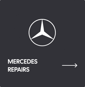 A black sign with a white Mercedes-Benz logo, the text 
