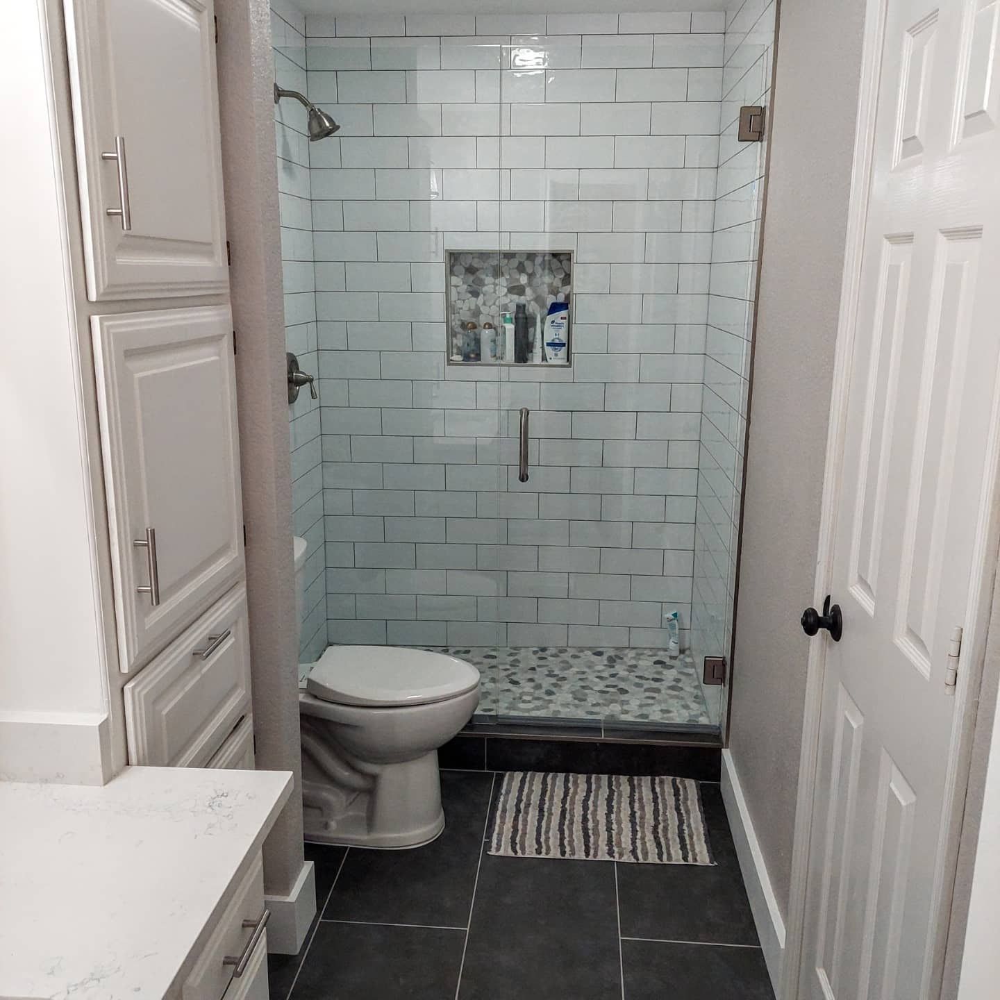 a bathroom with a toilet and a walk in shower