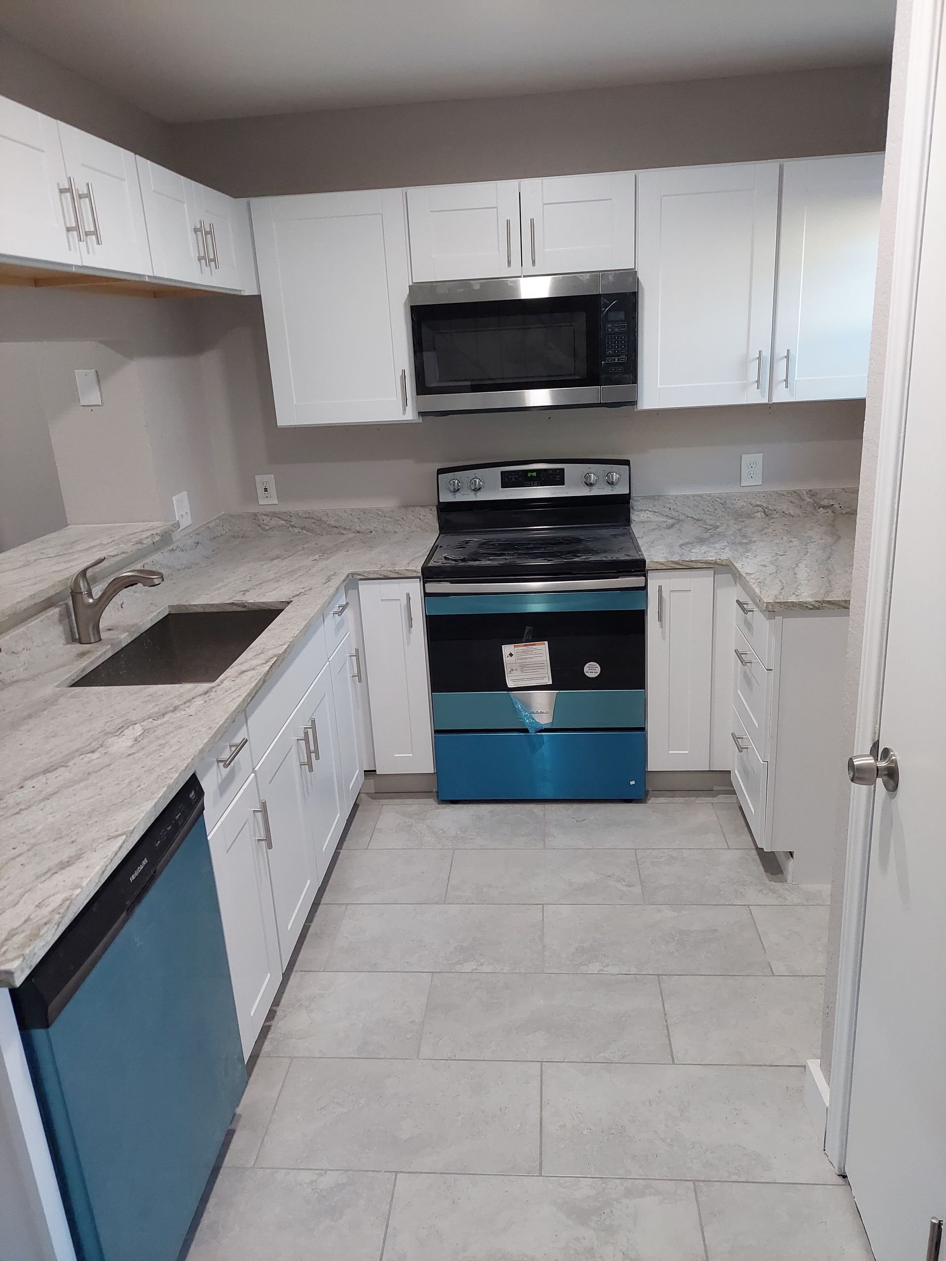 a bathroom with a tub , sink , shower and window .