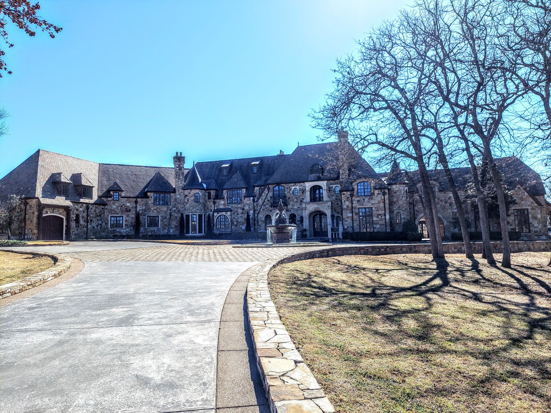 a bathroom with a toilet , sink , and black and white tile floor .