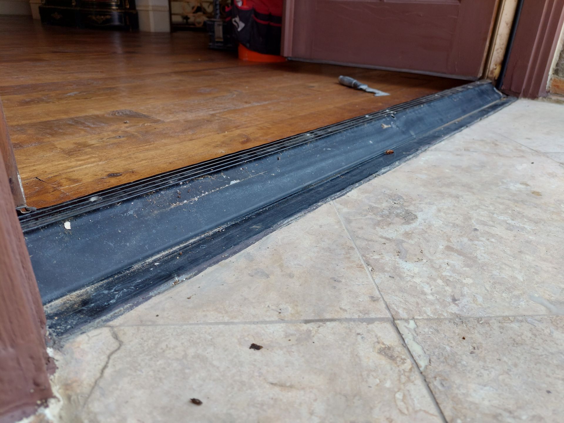 a door with a ramp leading to it and a wooden floor .