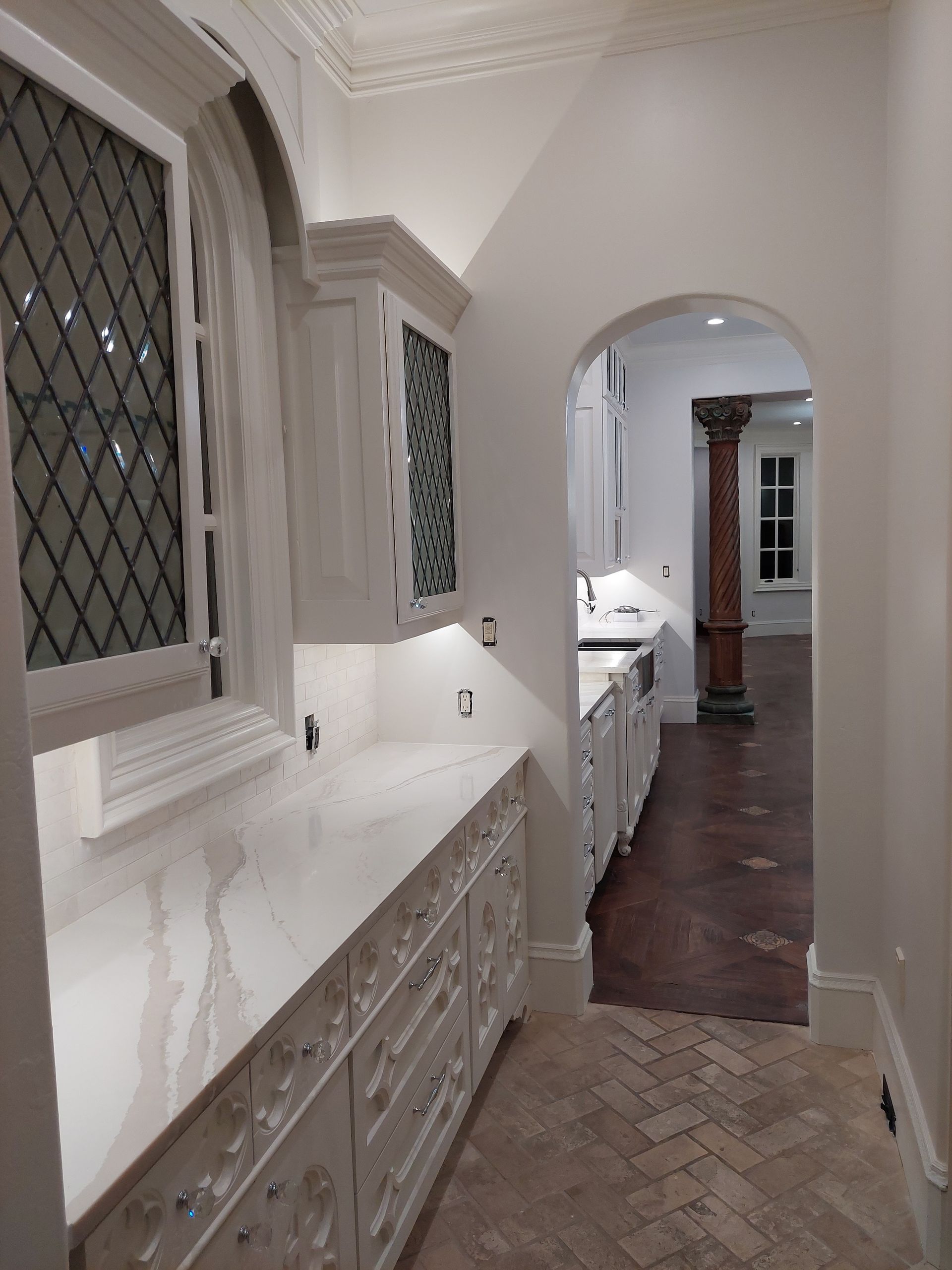 a bathroom with a toilet , sink , and black and white tile floor .