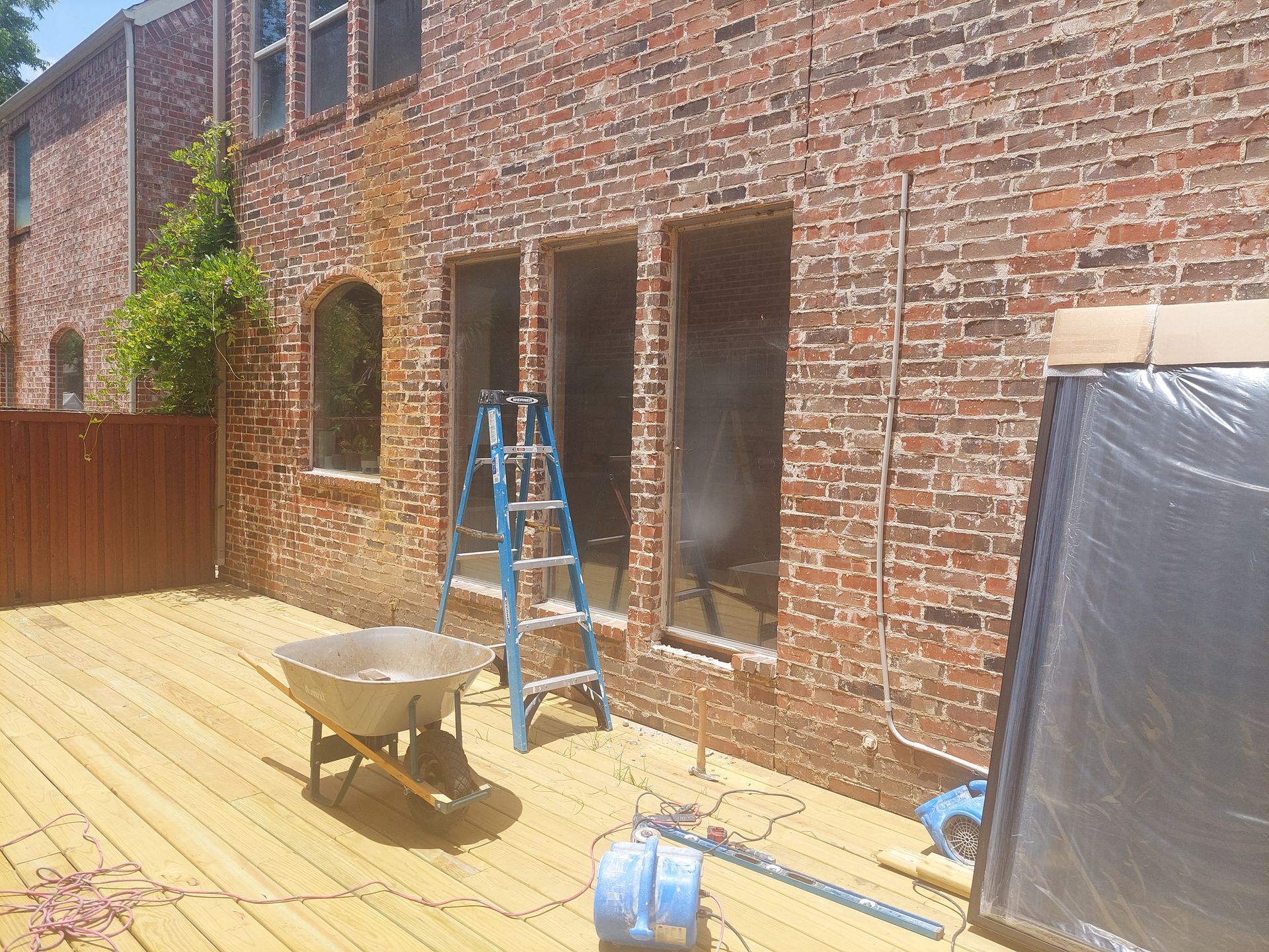 a bathroom with marble walls and a walk in shower with a glass door .