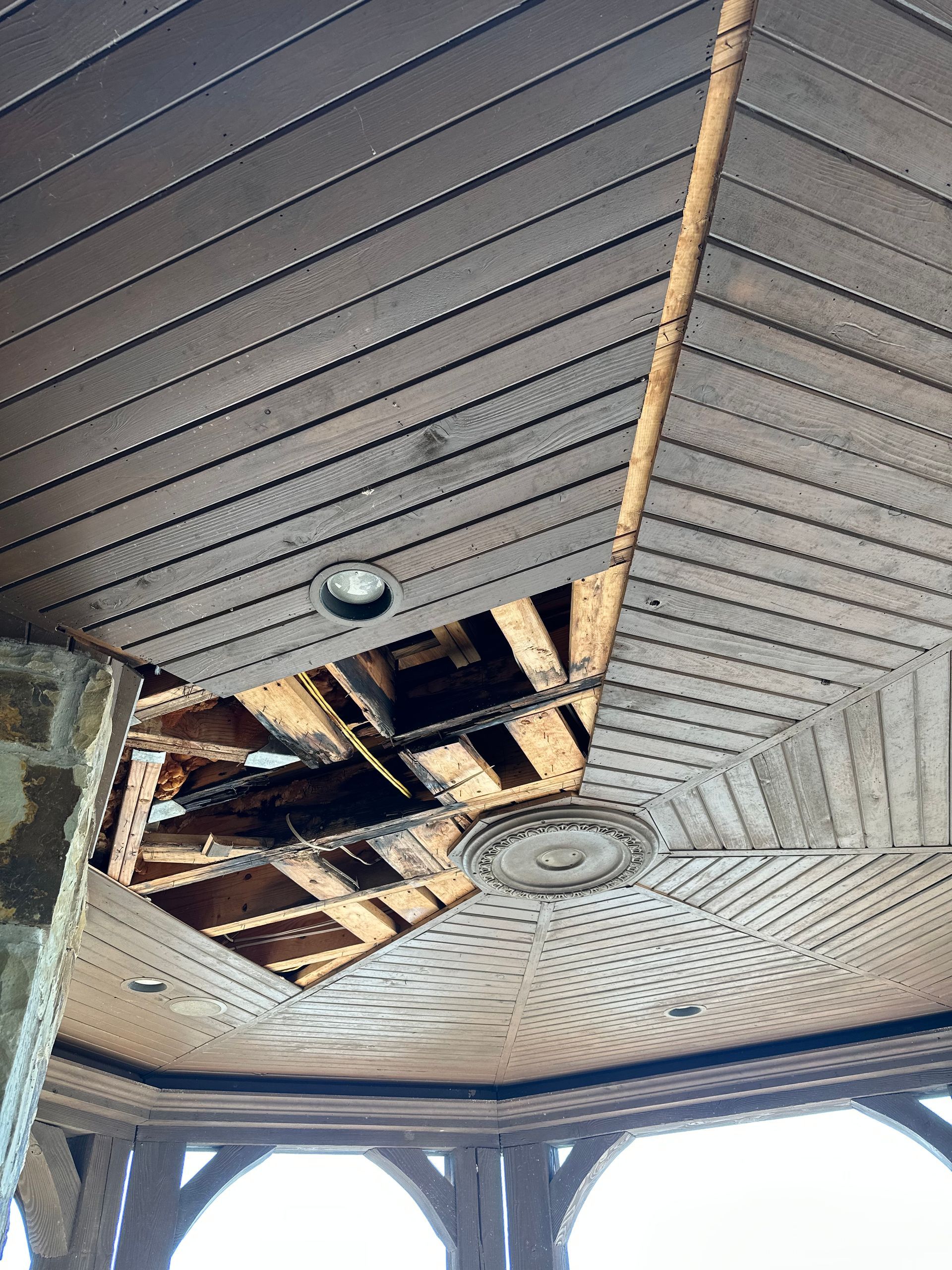 the ceiling of a building with a hole in it