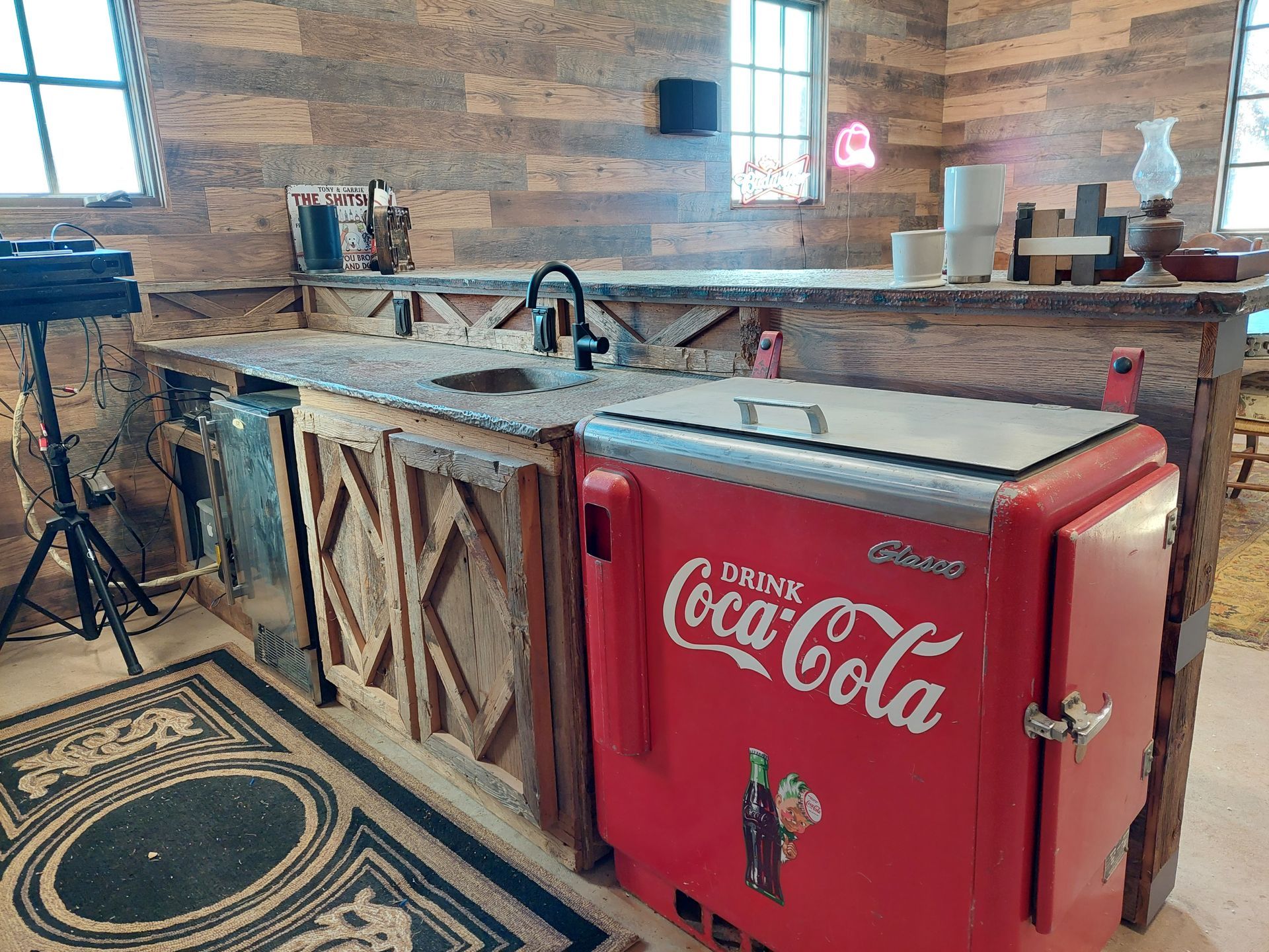 a bathroom with two sinks , two mirrors and a walk in shower .