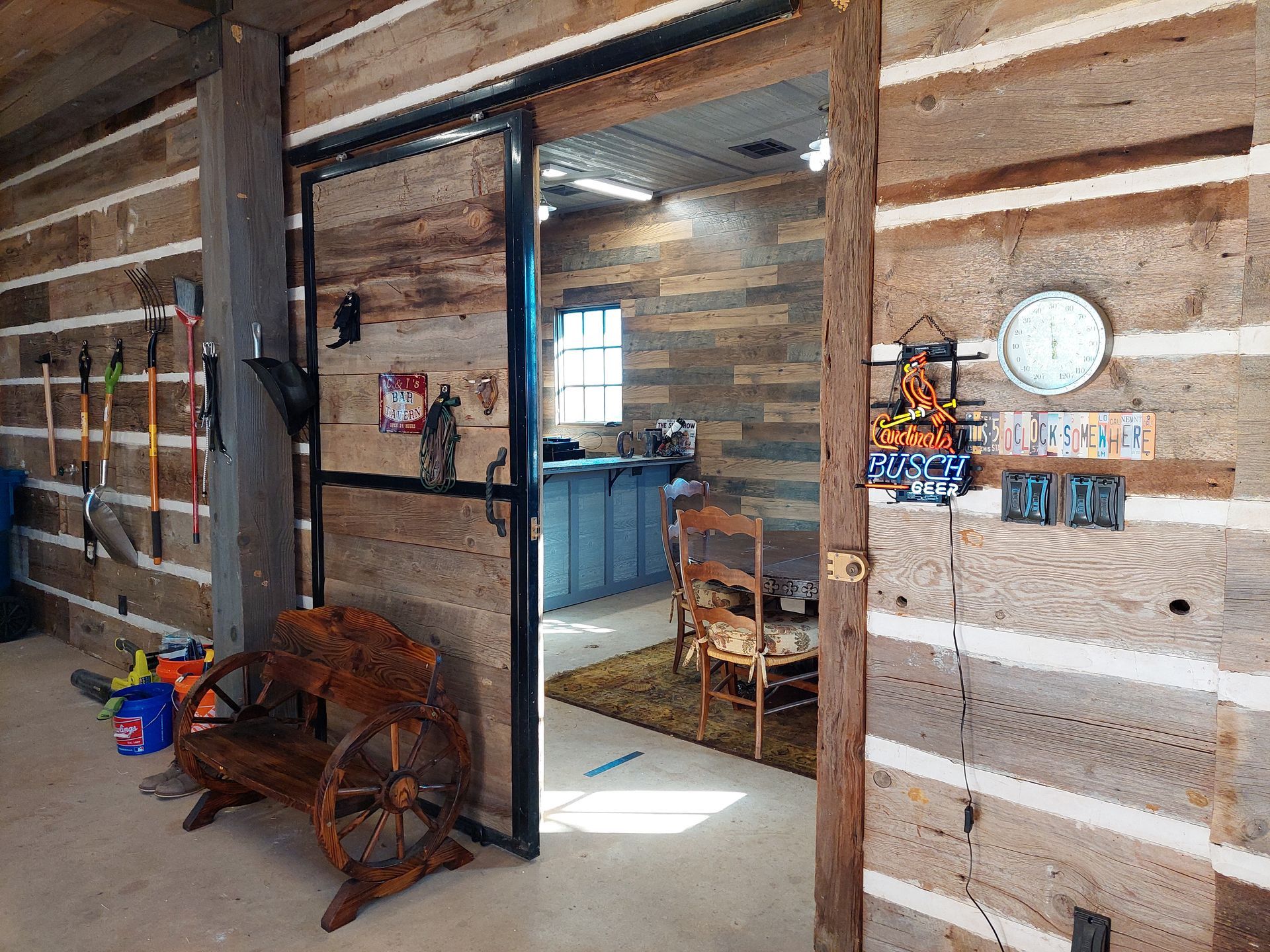 a shower with white tiles and a black shower head