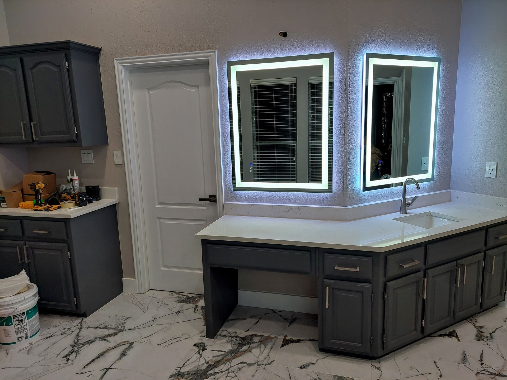 a bathroom with two mirrors and a sink .