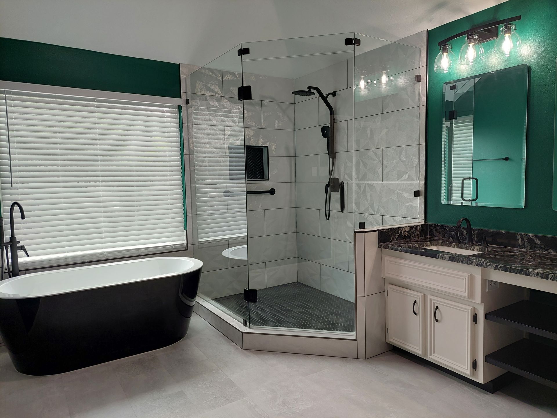 a bathroom with a bathtub , sink , shower and mirror .