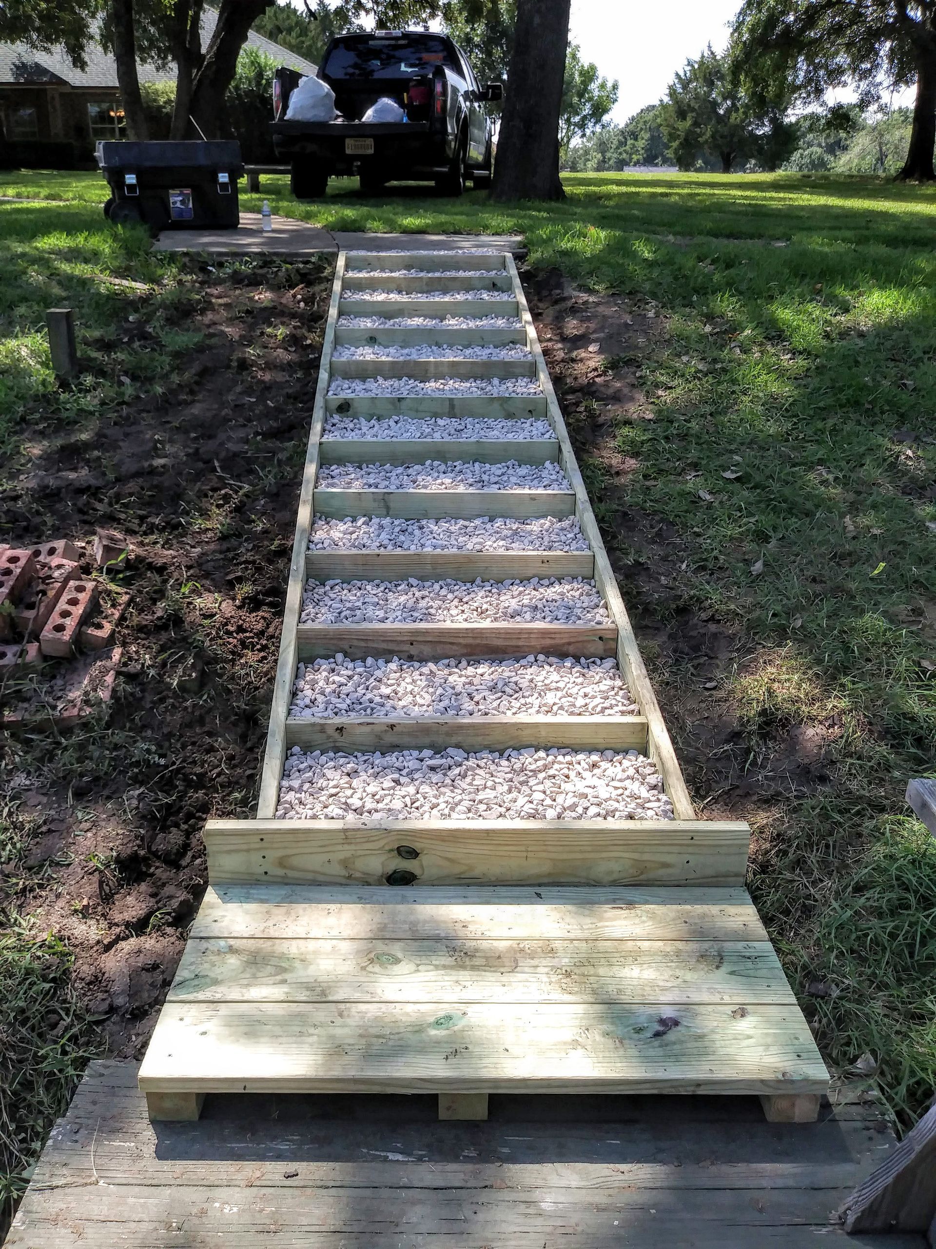 a bathroom with a walk in shower with a sliding glass door .