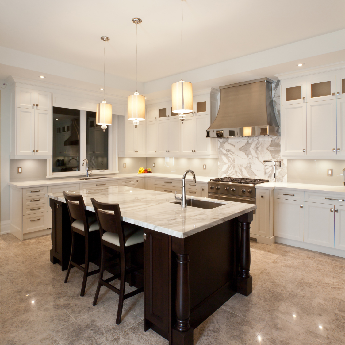 a kitchen with white cabinets and a large island