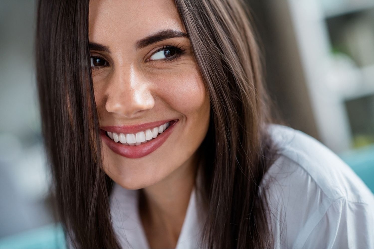 Close up portrait of sweet nice person smiling toothy with shiny veneers in comfy house living room