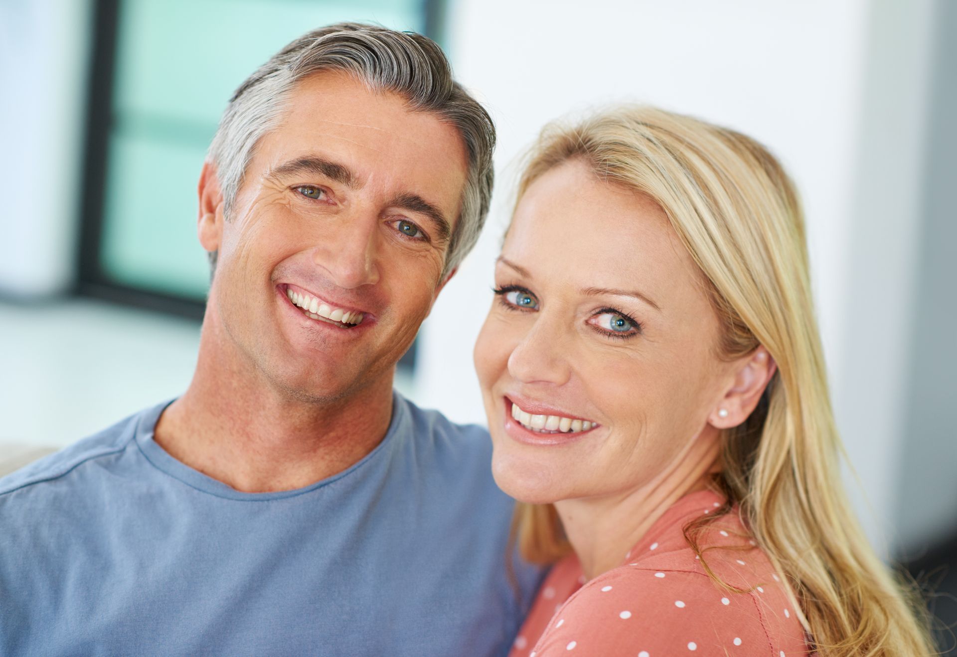 Smiling couple showing off healthy teeth after All-on-4 dental implants at Garden City Dental Practice in Toowoomba.