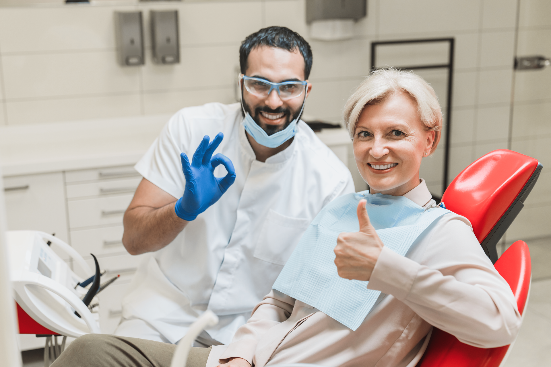 Doctor and patient smiling after root canal treatment