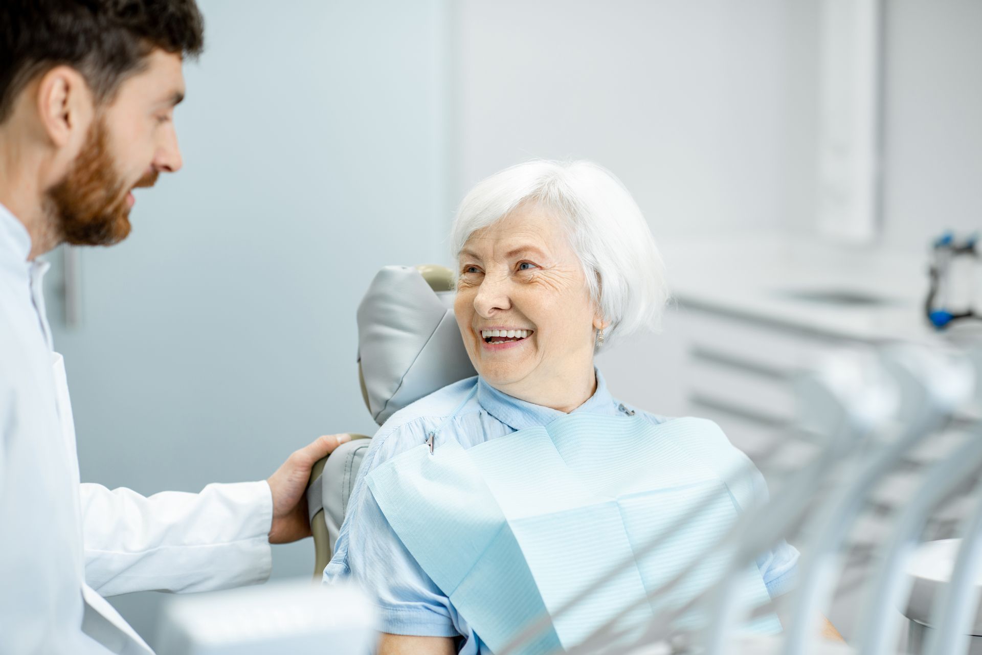 Old woman with dentures smiling to the doctor