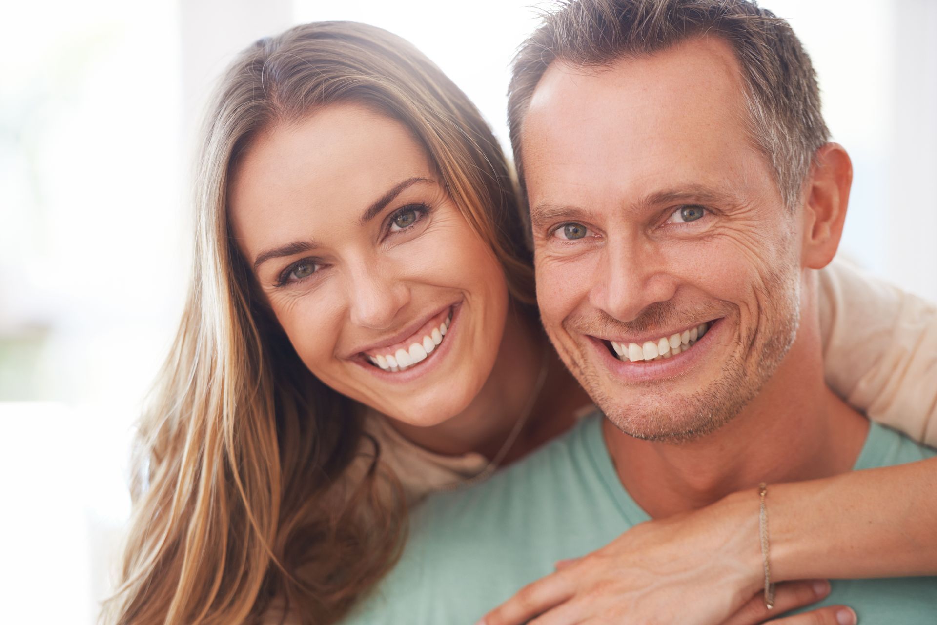 Happy couple smiling confidently after receiving dental implant treatment in Toowoomba at Garden City Dental Practice.
