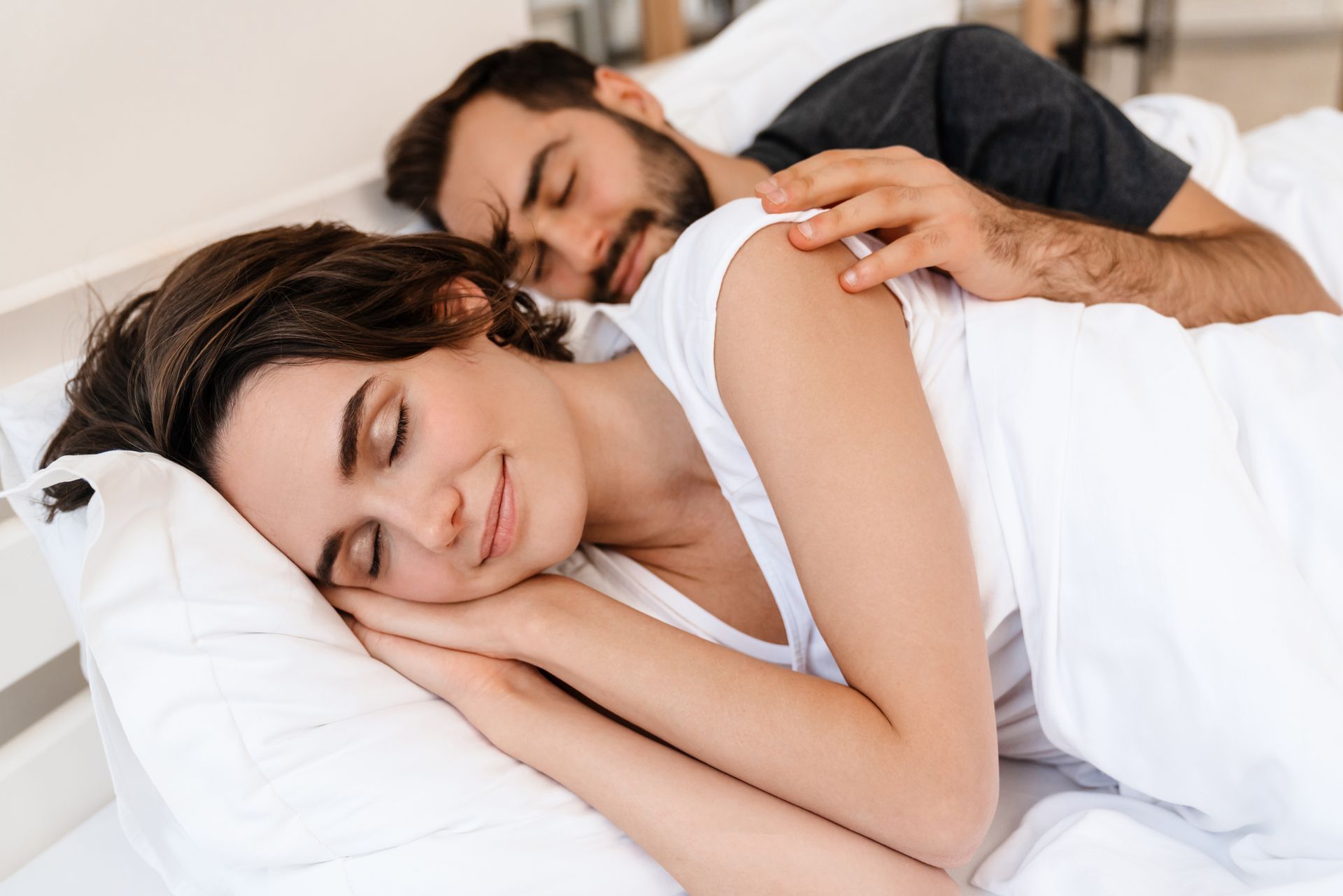 Young couple sleeping peacefully after sleep apnea treatment in Toowoomba at Garden City Dental Prac