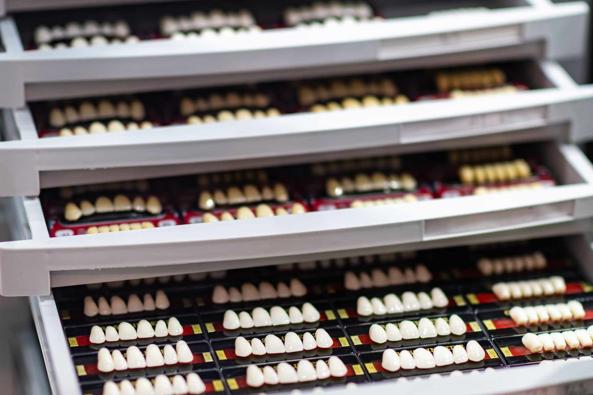 Drawer full of dental veneer samples in varying shades used for cosmetic smile makeovers at Garden City Dental Practice in Newtown.