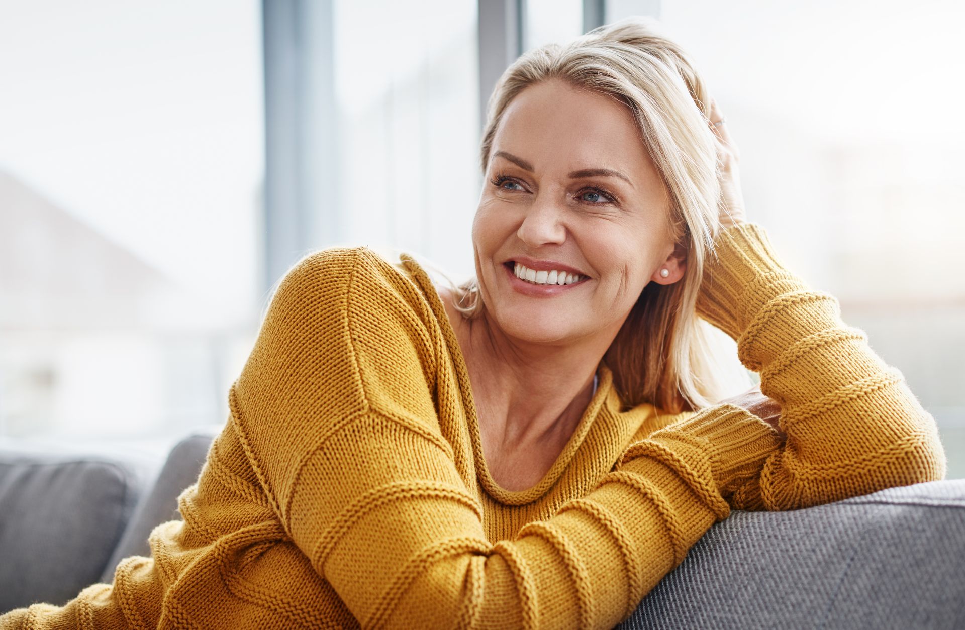 A woman smiling in a dental clinic after dental implant treatment in Toowoomba