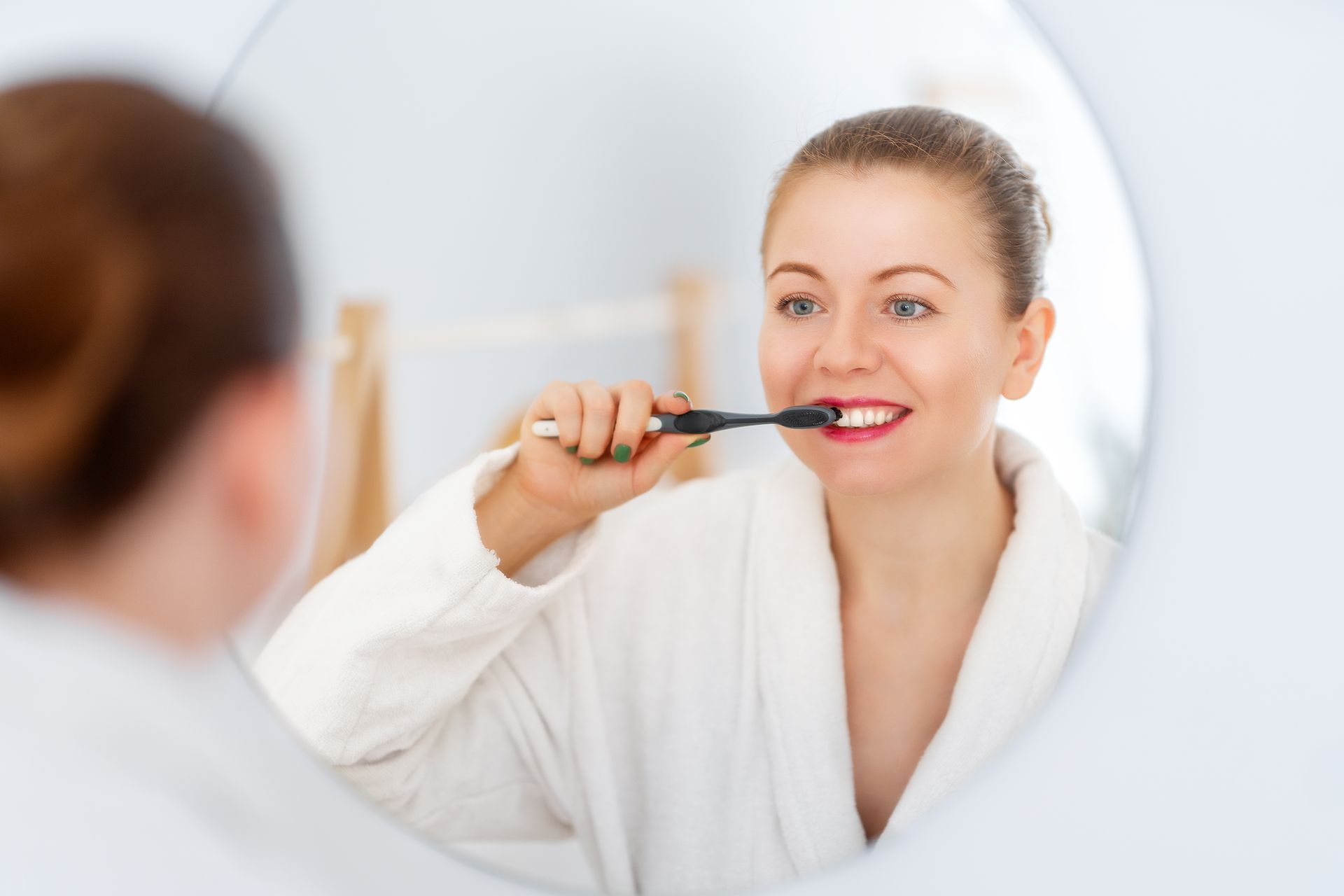 Woman brushing teeth with proper technique for oral health care