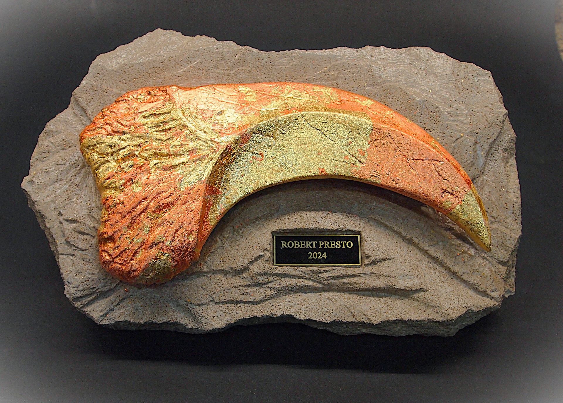 A fossil of a dinosaur claw on a rock