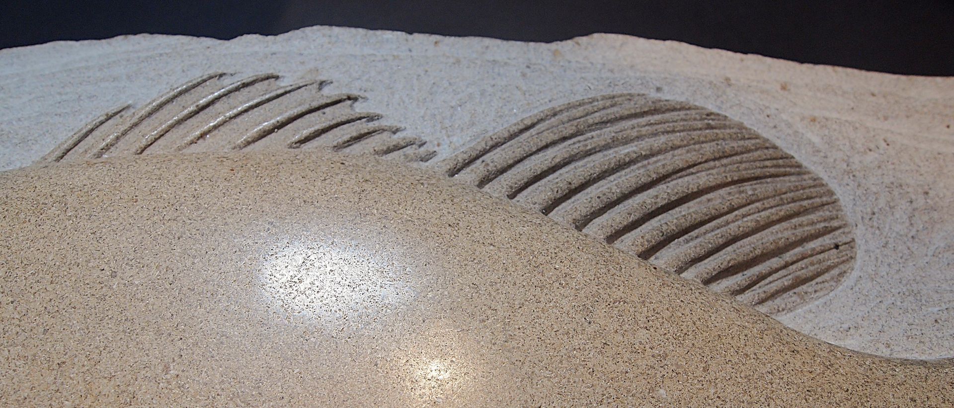 A close up of a pile of sand with a swirl in the middle.