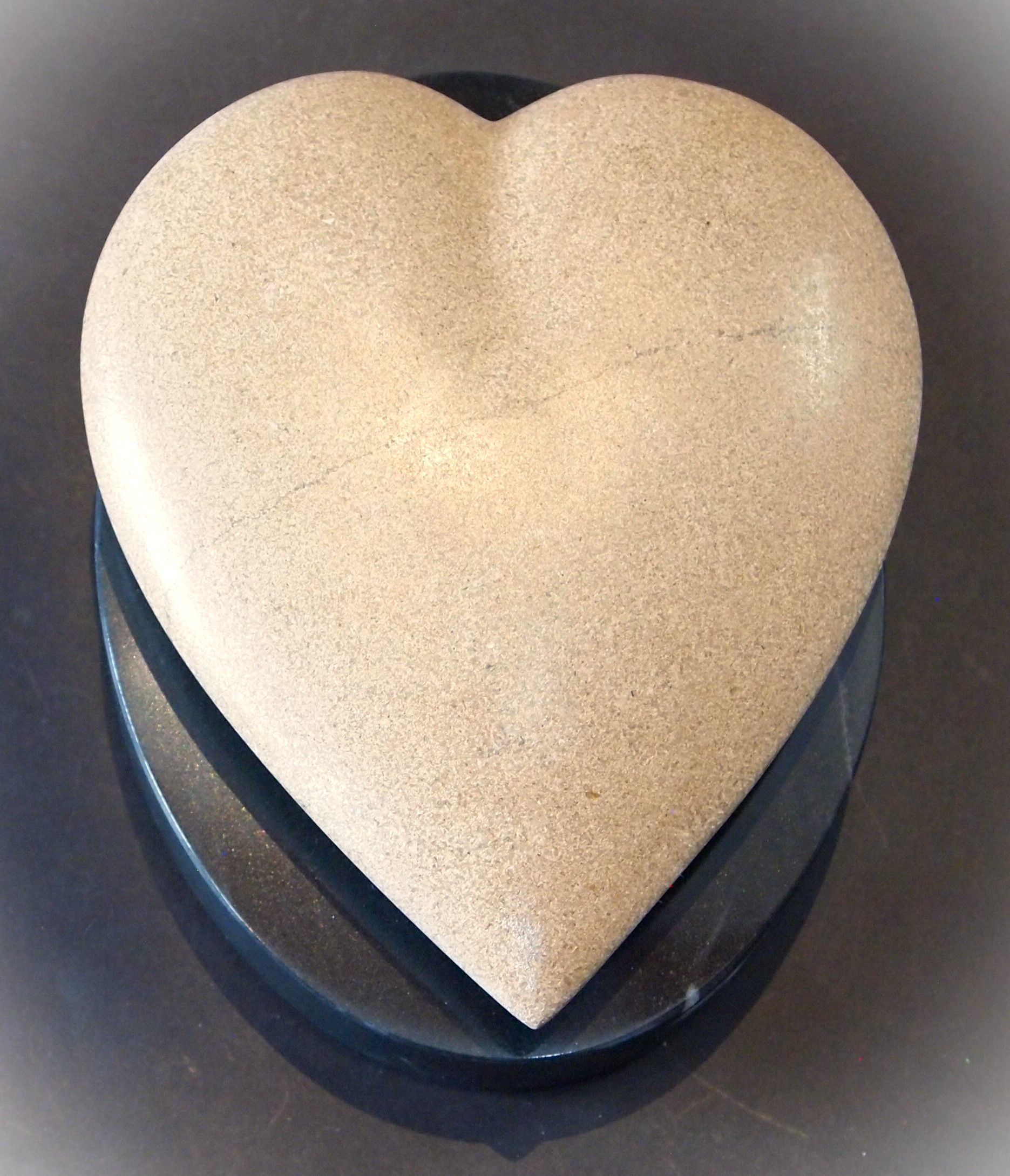A heart shaped object is sitting on a table