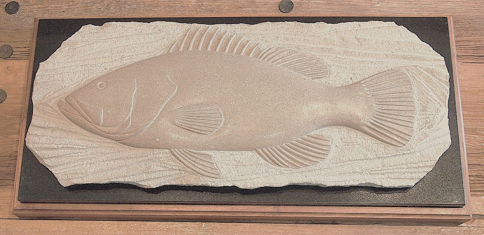 A picture of a fish on a wooden surface
