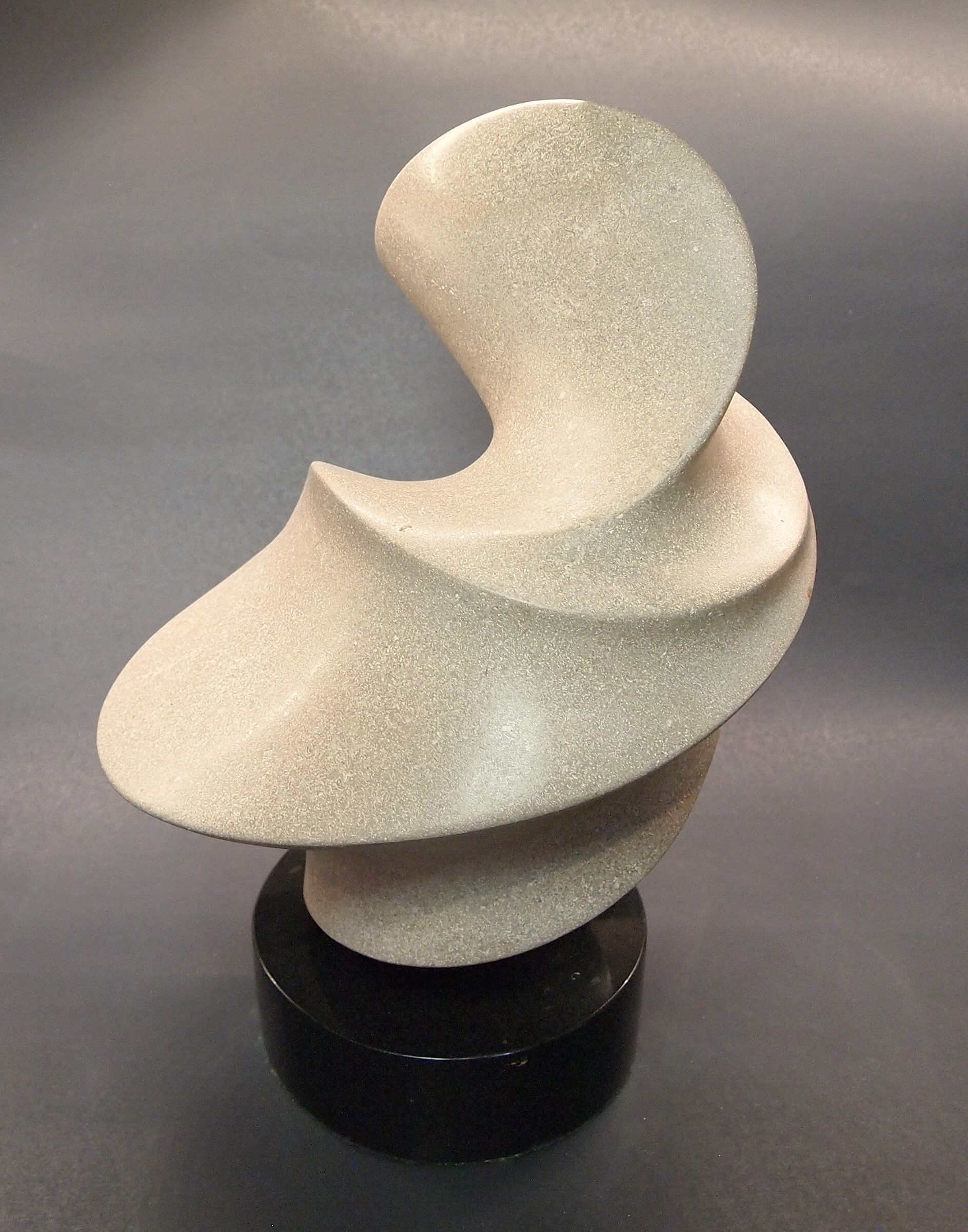 A sculpture of a spiral on a black base