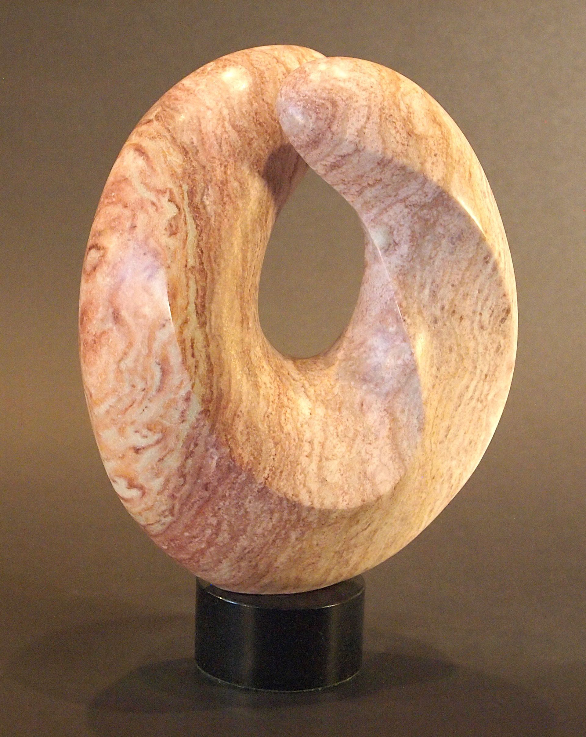 A wooden sculpture with a hole in the middle