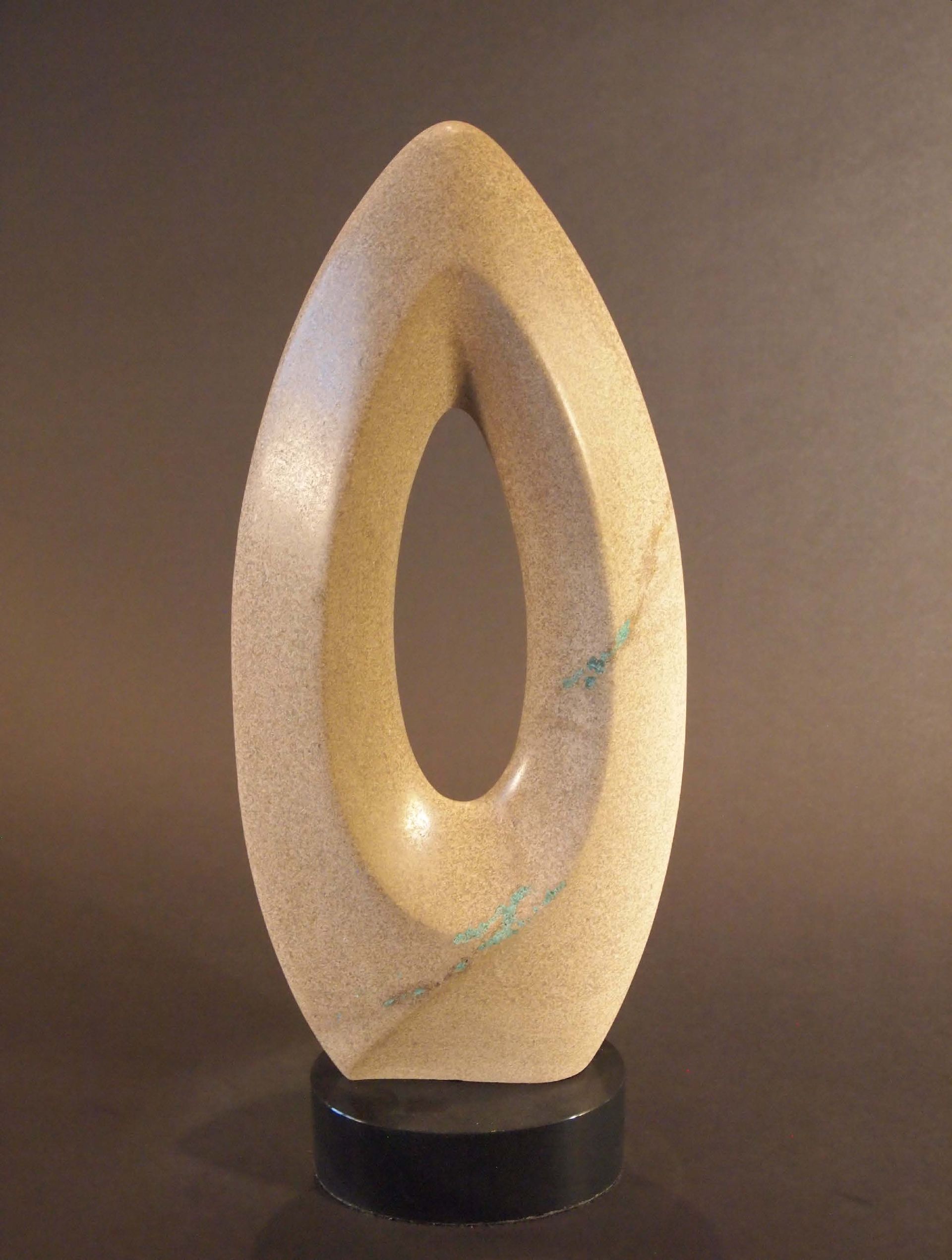 A sculpture of an oval with a hole in the middle