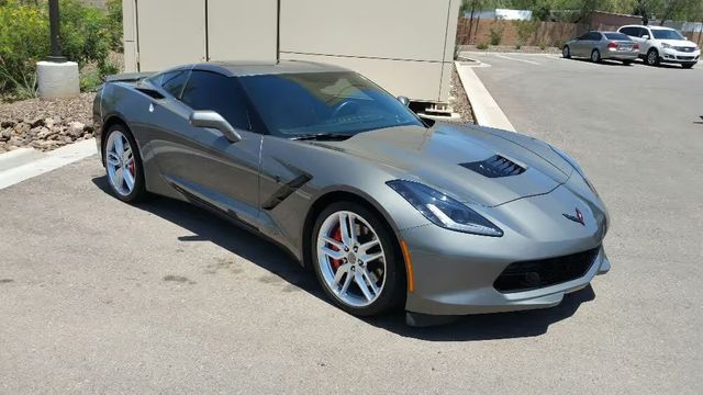 Gray Chevrolet Corvette parked outside a building on a sunny day