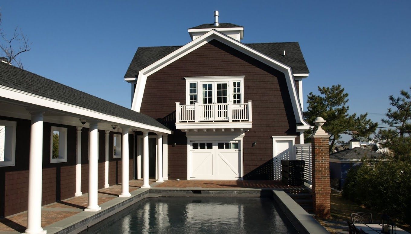 A large house with a swimming pool in front of it