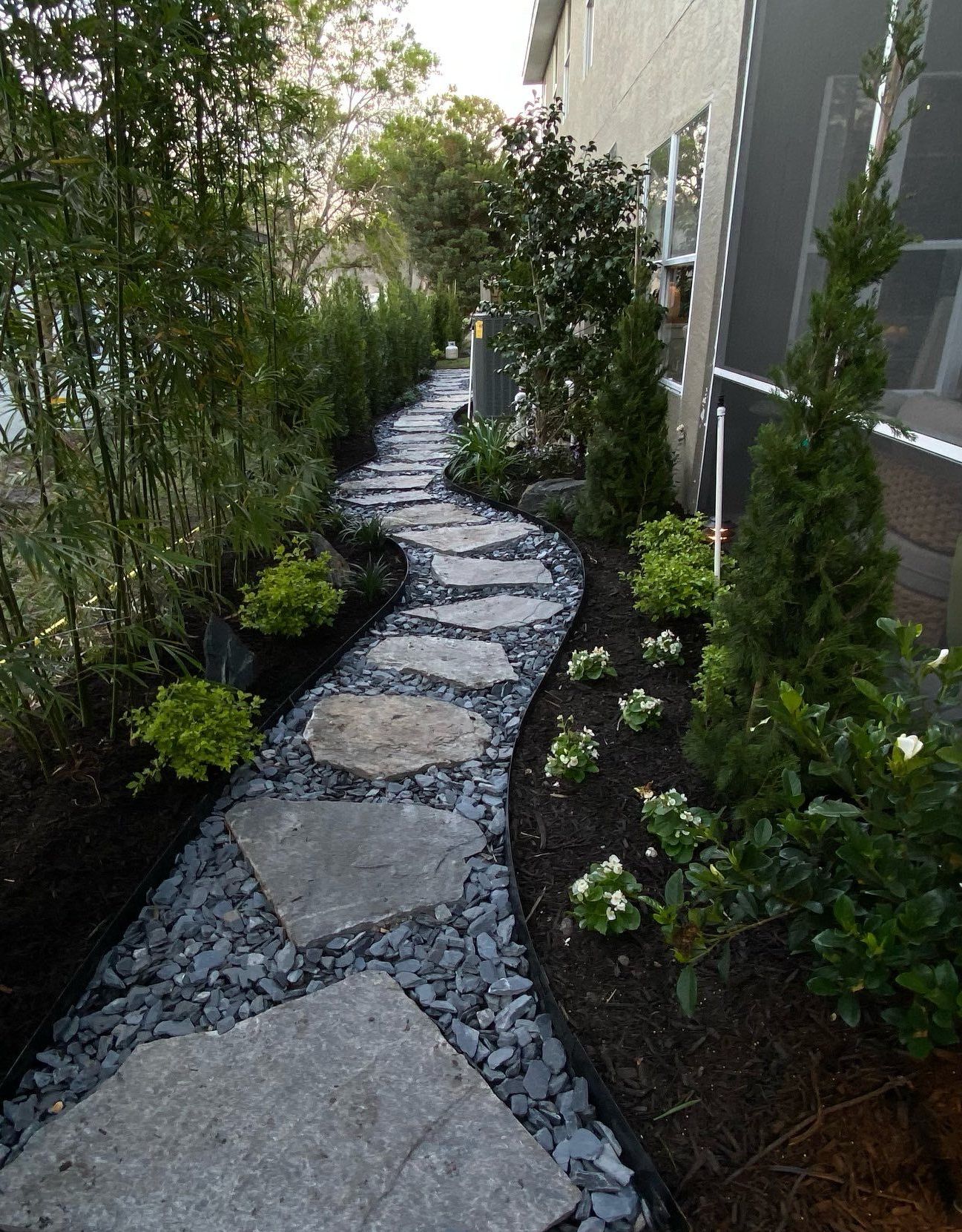 there is a stone fireplace in the backyard of a house .